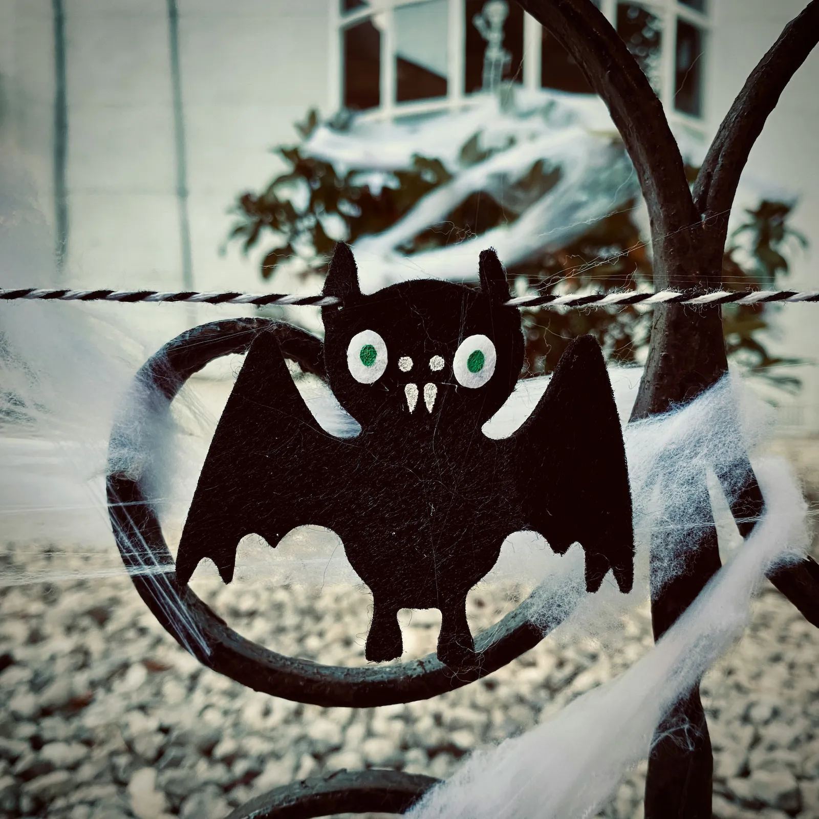 Handmade bat decoration on a wintry gate